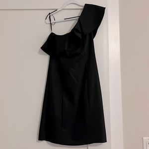 A line one shoulder little black dress with ruffled neckline. Hit above knee.
